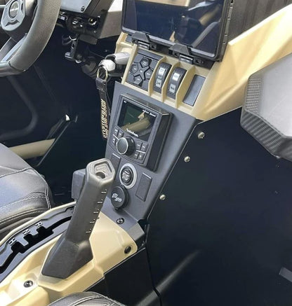 Close-up of a rugged, utilitarian StayFlush Cyclops Console + 2-Switch — Universal UTV Center Console by StayFlush Motorsports, showing dashboard controls, touchscreen, ignition key, joystick-style gear lever, and part of a leather seat.