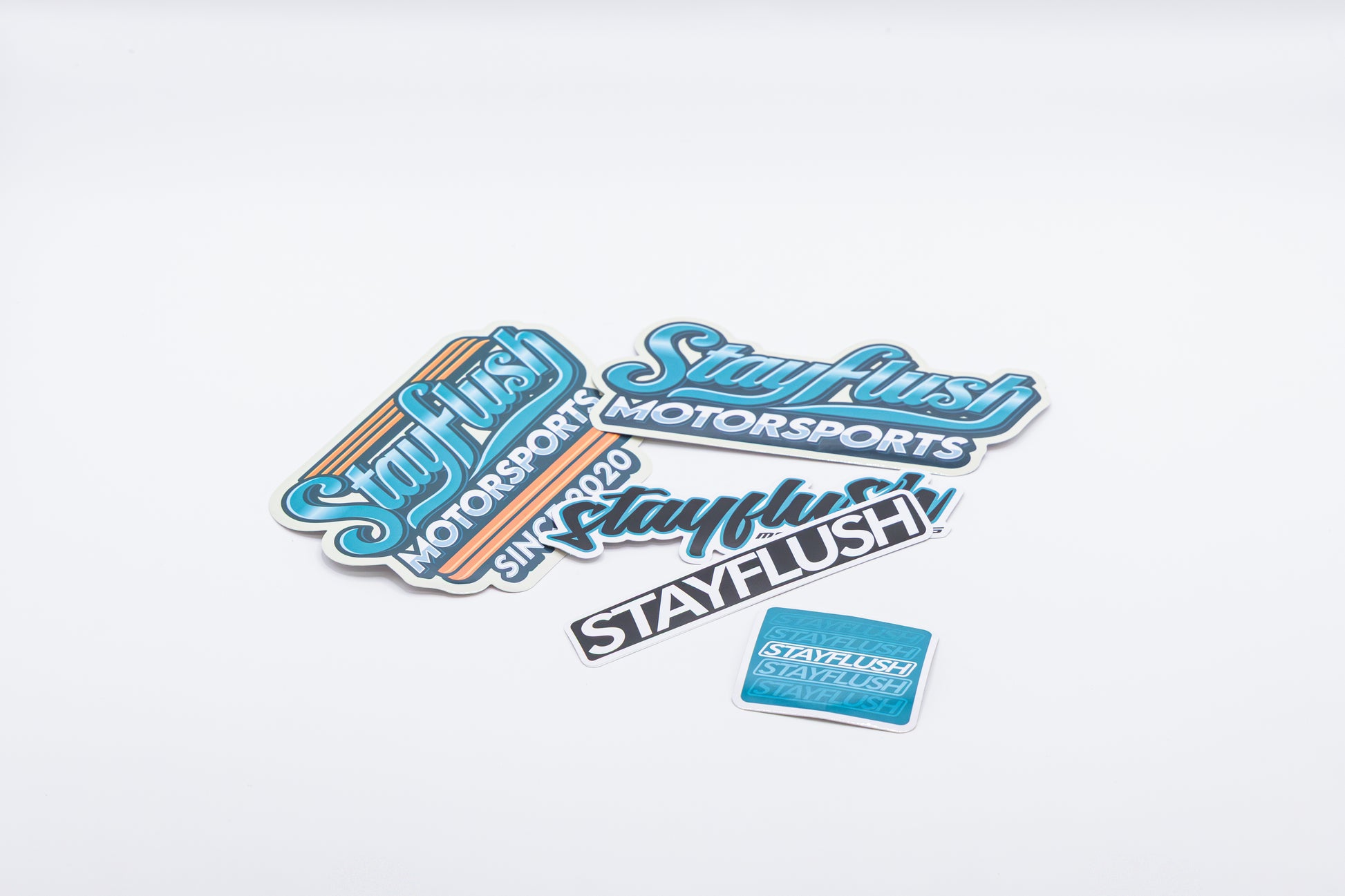 The StayFlush Motorsports Sticker Pack features high-quality stickers in various shapes, sizes, and colors, displayed on a plain white background.
