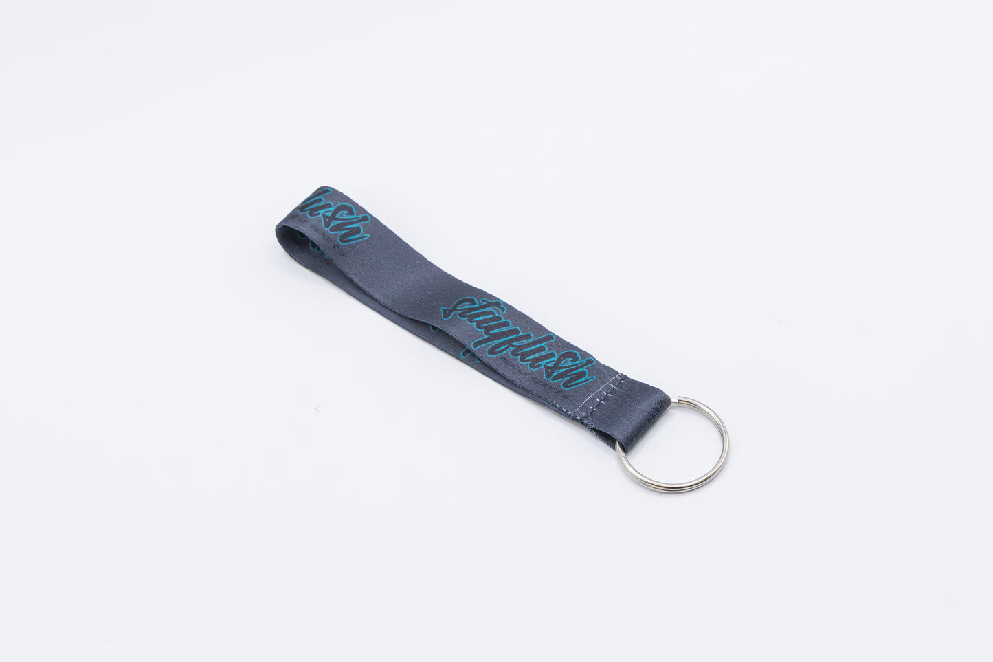 The StayFlush Motorsports Keychain Lanyard is a gray fabric car wrist keychain with teal "rayhush" text and a silver metal key ring, shown on a plain white background.